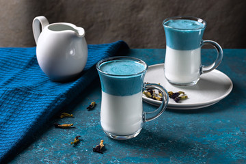 Blue matcha latte with milk. Fashionable drink from butterfly peas. Horizontal orientation