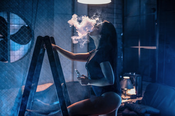 Young sexy woman is vaping. A cloud of vapor. Vape.