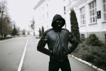 portrait of man thief in mask on the street