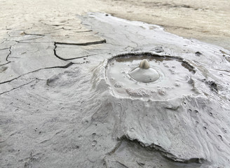 Background bubbling mud volcano cone