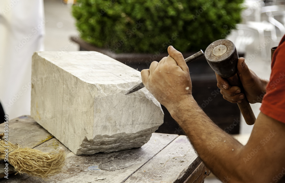 Wall mural Man carving stone