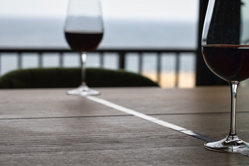 Footage of stylish wine glasses for wine tasting in fine dining winery with red wine on table. one...