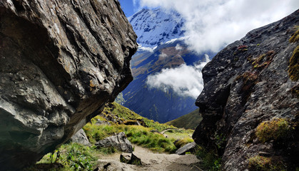View Between the Rocks,Mountain landscape with blue sky,clouds and Big Rocks from Annapurna Base Camp Nepal.landscaping with big rocks in Machapuchare