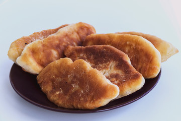 Fried pies with filling on a white table