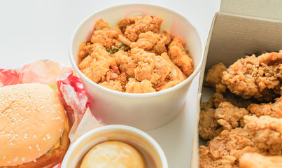Fried chicken and burgers with rice, mashed potatoes on the table. Fast food, ready to eat easily.