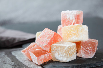 Turkish sweets (Turkish delight) of different colors in powdered sugar