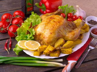 Chicken baked in the oven with potatoes.