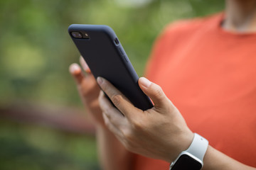 Hands using mobile phone in spring nature