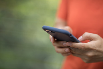 Hands using smartphone at outdoors