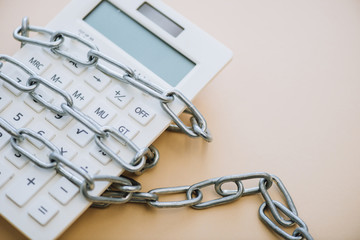 High angle view of calculator with chain on white background