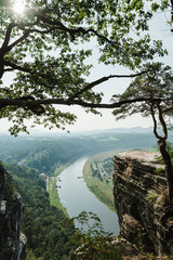 Landscape on the river Elbe from above through rocks and trees in Saxon Switzerland. View from the viewpoint of Bastei in Saxon Switzerland Germany, Dresden to river Elbe. Wallpapers.Vertical