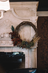 Beautiful hand made wreath hanging in the fireplace room