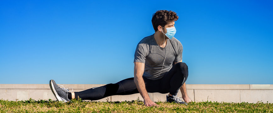 athlete does muscle stretching with sanitary face mask