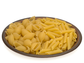Italy dry raw pasta penne rigate and conchiglie on the plate
