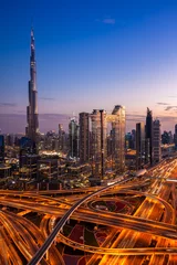 Foto op Plexiglas The view of the futuristic Dubai skyline and Sheikh Zaed road at dusk, UAE. © Elena Ermakova