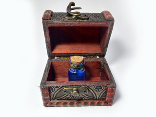 Wood chest with potion blue. old treasure casket isolated on white background. Alchemy set with flasks. small glass bottles with colored liquid for game role play. magic potions.