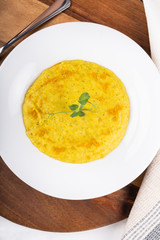 Mixed vegetable cream soup in a white bowl, isolated on a white background, on wooden cutting board