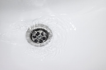 water flow into drain in bath