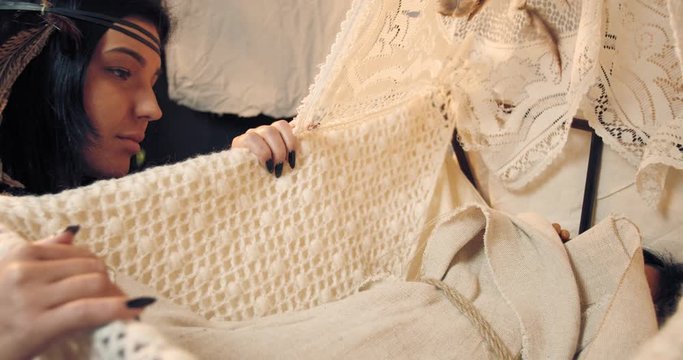 Young indian mother in traditional clothes is kissing her child, 4k