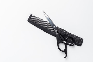 scissors and comb on a white background