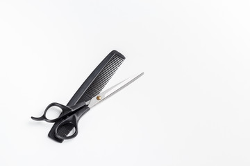 scissors and comb on a white background. Place for text