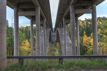 View of the bridge from below. Concrete bridge construction. Motorway