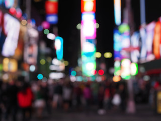 Defocus blur of New York City street scene at night with yellow taxi cabs, cars, lights and...