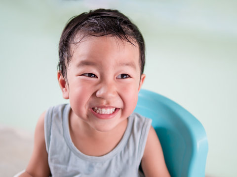 Asian cute child boy laughing and smiling with sweat on hair and happy face isolated clean background. Childhood happiness activity in summer.