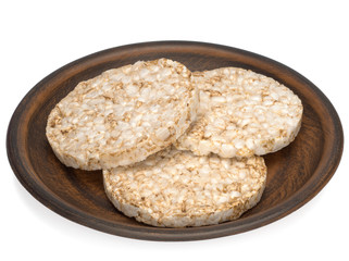 Puffed rice bread in a plate isolated on white background, diet crispy round rice waffles