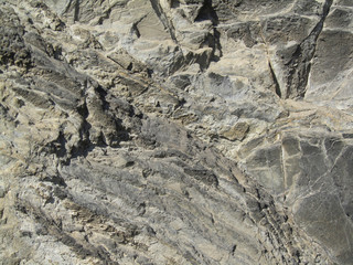 Stone background. Grunge background with rough stone surface for your design. Gray brown rock texture. Detail.