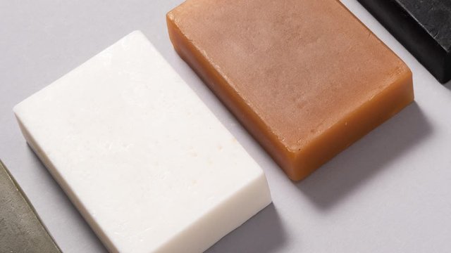 Set of different handmade soap on black background