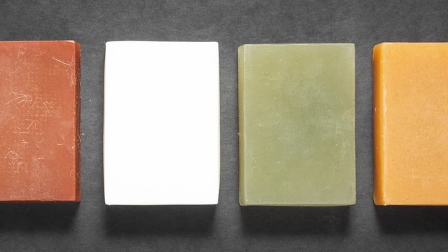 Set of different handmade soap on black background