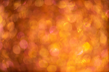 Orange gold abstract background with bokeh defocused lights.