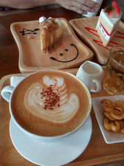 Close-up of Cappuccino with Crackers and Cakes on the Table, Vertical