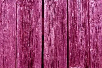 Weathered pink toned rustic wood planks with nails.