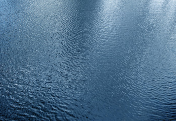 Waves on lake water from top.