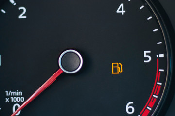 car. Dashboard. Tachometer sensor, arrow on zero. Empty tank sign blinking. There is no fuel