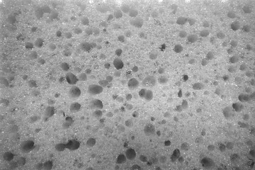 Cleaning sponge surface close up in black and white.