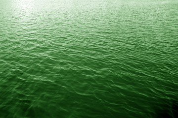 Waves on lake water surface.Green river water for St. Patrick's day