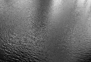 Waves on lake water from top. Black and white