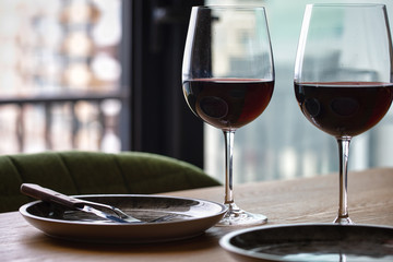 Luxury red wine. Delicious drinks, made from delicious grapes in wine glass on the table. restaurant close up. red wine on table. plate with wine on table. restaurant open. catering industry