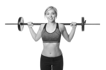 smiling sporty woman exercising with barbell