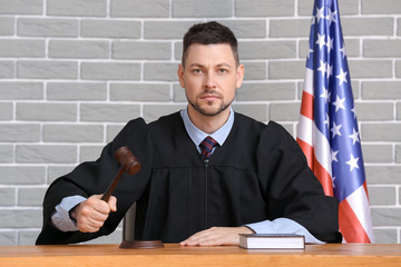 Male judge at table in courtroom