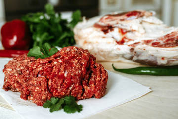 Fresh red minced meat on a background of meat and spices