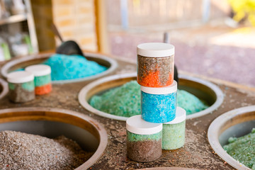 Dead Sea colorful salt and scoop on a buckets at a souvenir shop in Kalia Beach, West Bank.