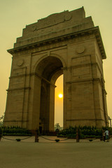Fototapeta na wymiar Sunrise at India Gate, New Delhi / Morning Cycling | Silhouette of India Gate, Vijay Chowk, Sun behind India Gate/ Empty India Gate, War Memorial