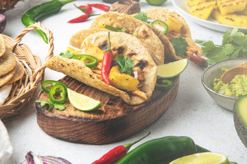 Mexican cuisine - mexican tacos al pastor, pork meat, corn tortillas, chili pepper, pineapple, avocado, cilantro, lime