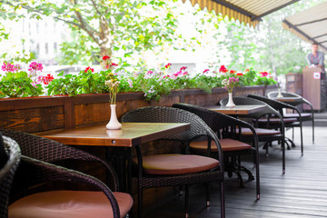 Interior of a summer playground without people with fresh flowers in pots. A cozy cafe.