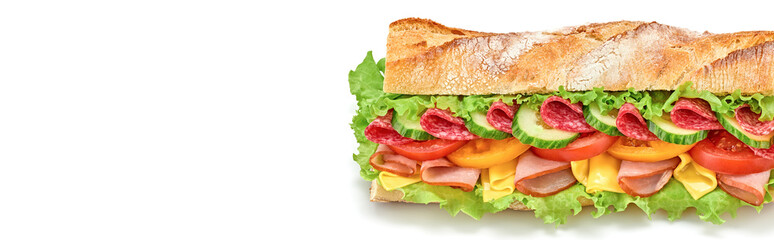 Submarine sandwich with ham, cheese, salami, tomato, lettuce salad, cucumber isolated on white. Homemade baguette sandwich with vegetables. Large sub sandwich closeup, banner