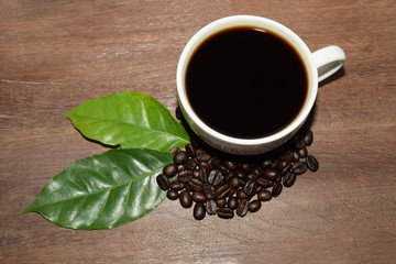 Roasted coffee beans with a white coffee mug